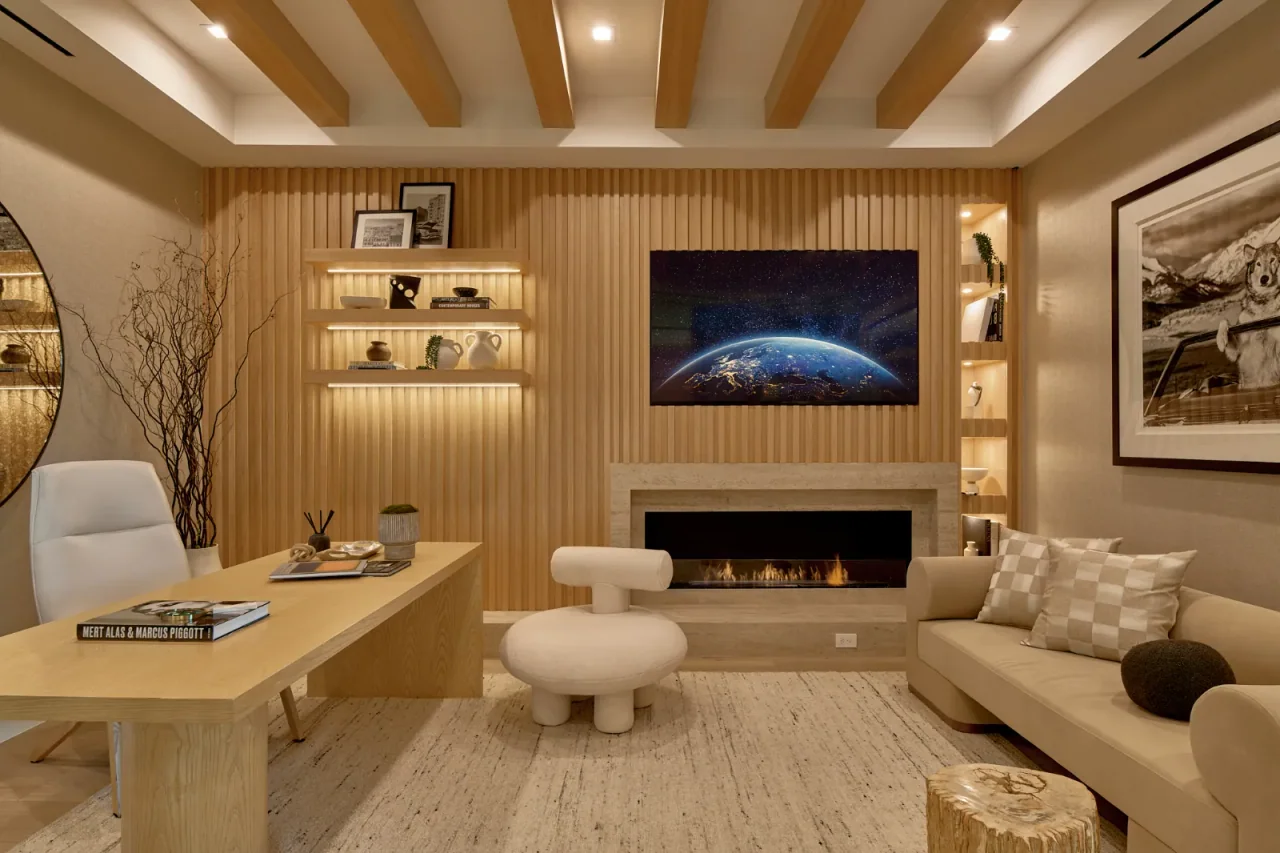 Sitting room with fireplace and display shelving at Chalon Road.
