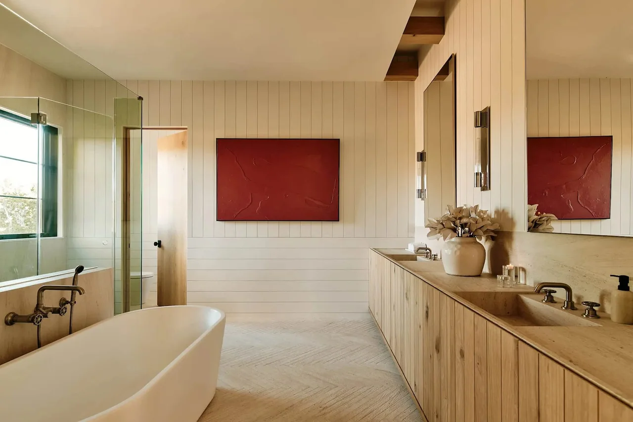 Long bathroom vanity beneath high windows at Dobbins Place.
