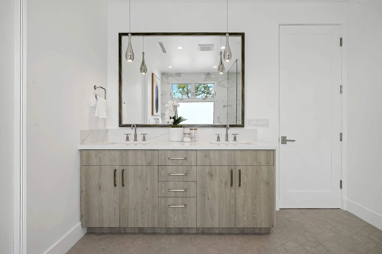 Double vanity beneath a wide mirror at Fairburn Avenue.