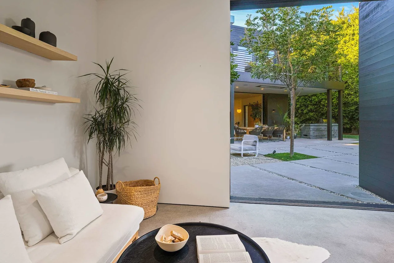 Built-in shelves beside a seating area opening to the pool terrace at Halderman Street.