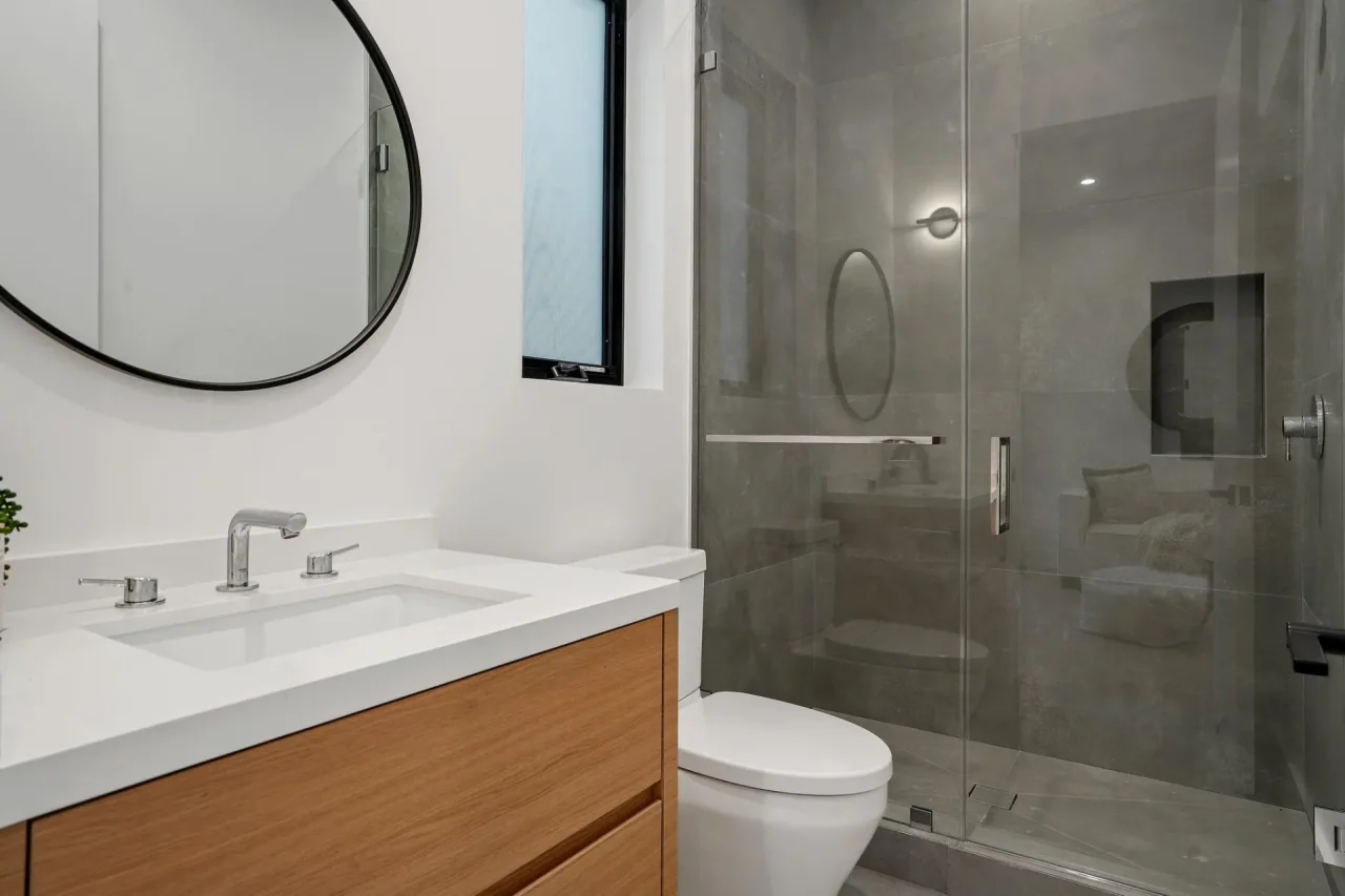 Vanity beside a glazed shower at Nowita Place.
