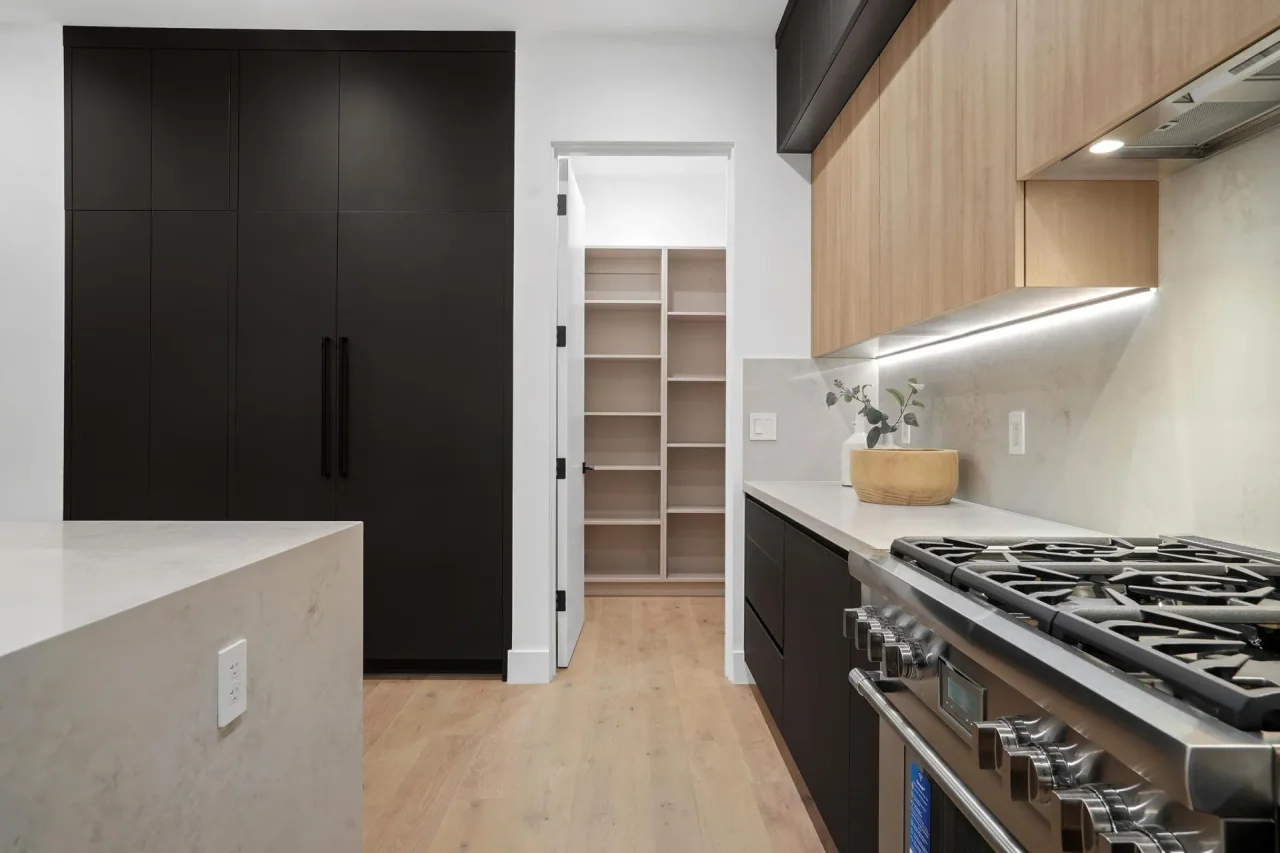Kitchen worktop and tall dark pantry at Nowita Place.