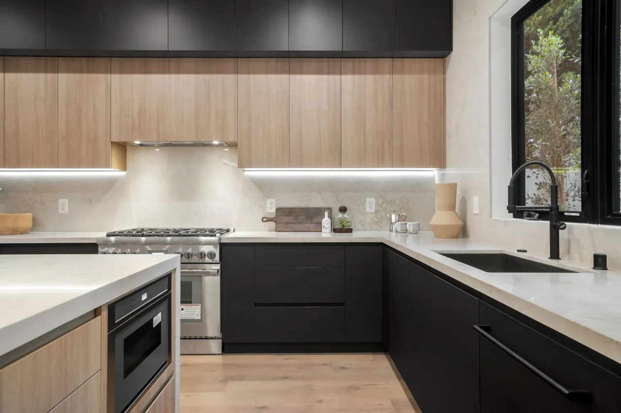 Range beneath timber cabinets and linear light at Nowita Place.
