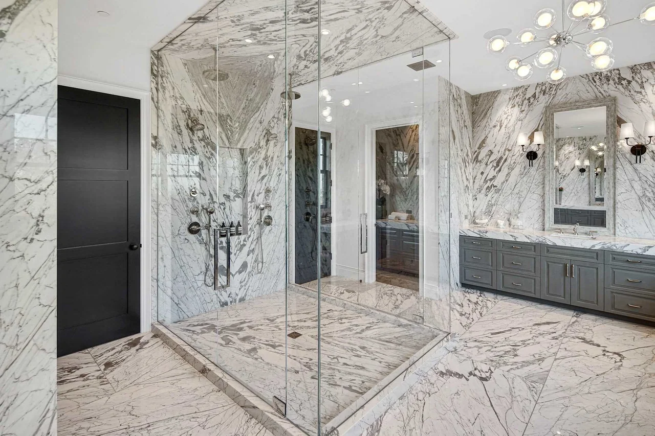 Glass shower with veined wall panels at Oakmont Drive.