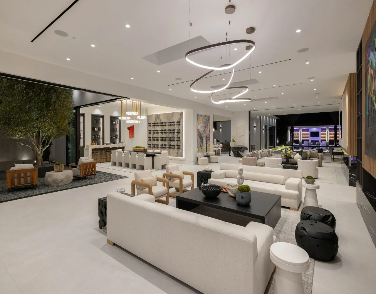 Open living room beneath circular lights at Petit Avenue.