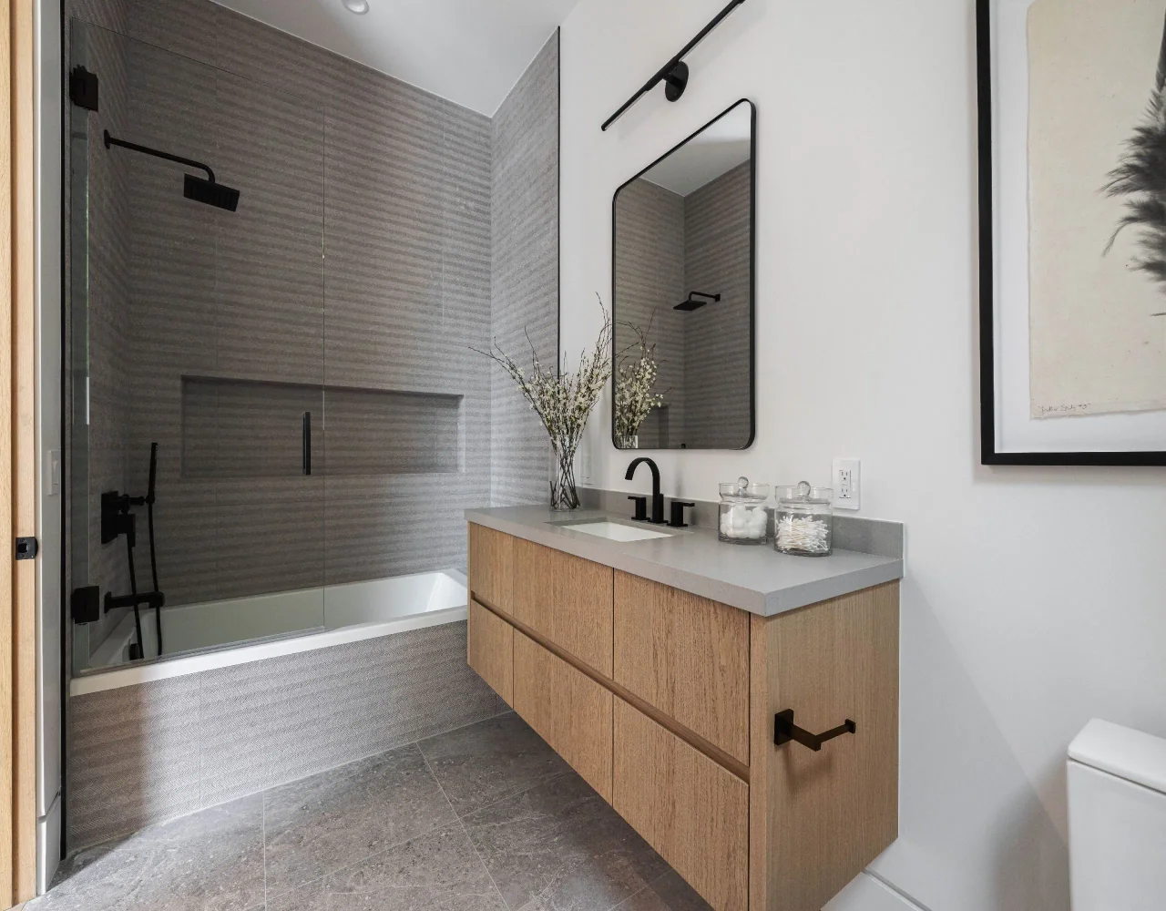 Floating vanity beside a tiled shower at Petit Avenue.