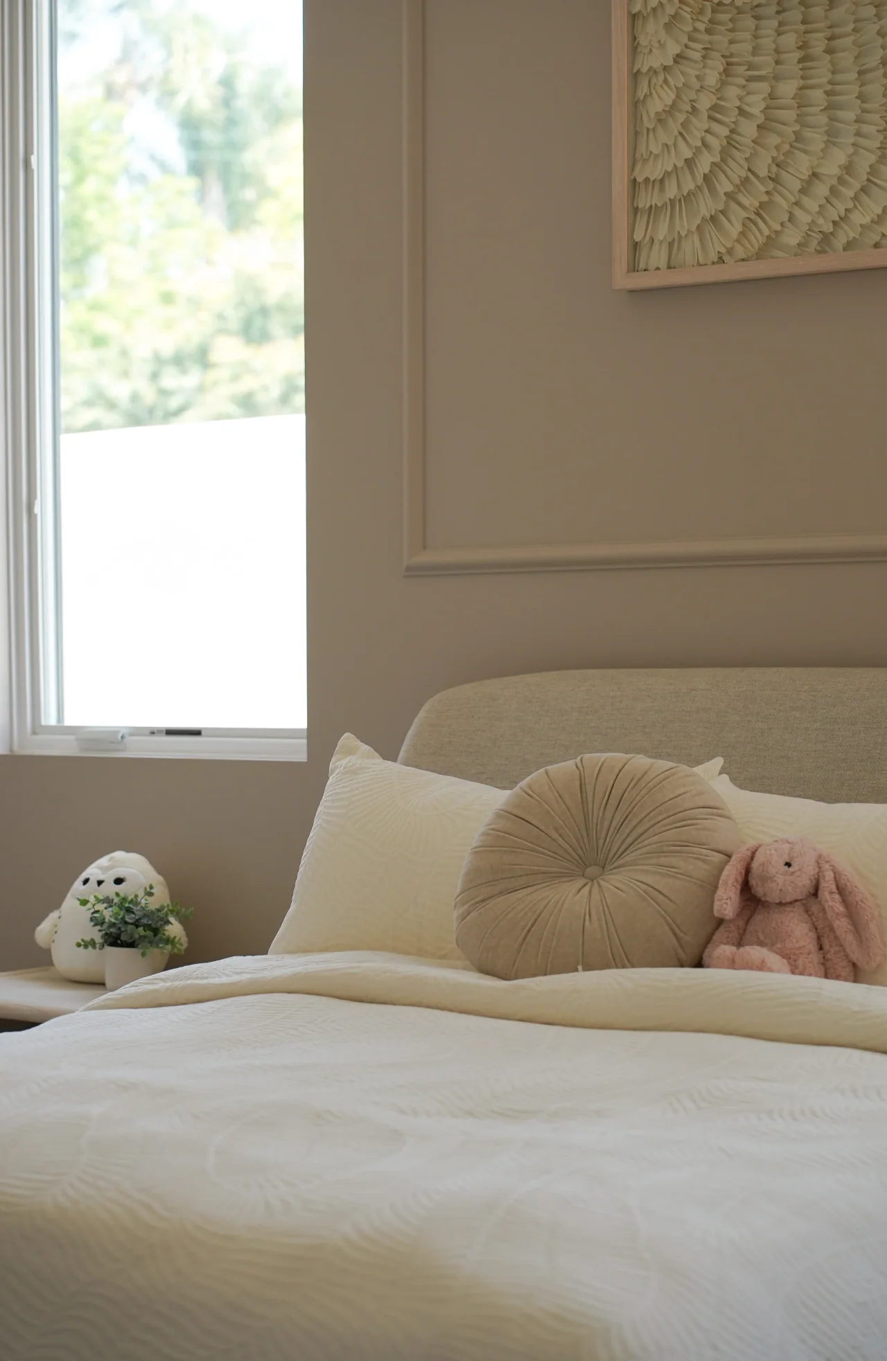 Bedroom beside a tall window at Rio Flora Place.
