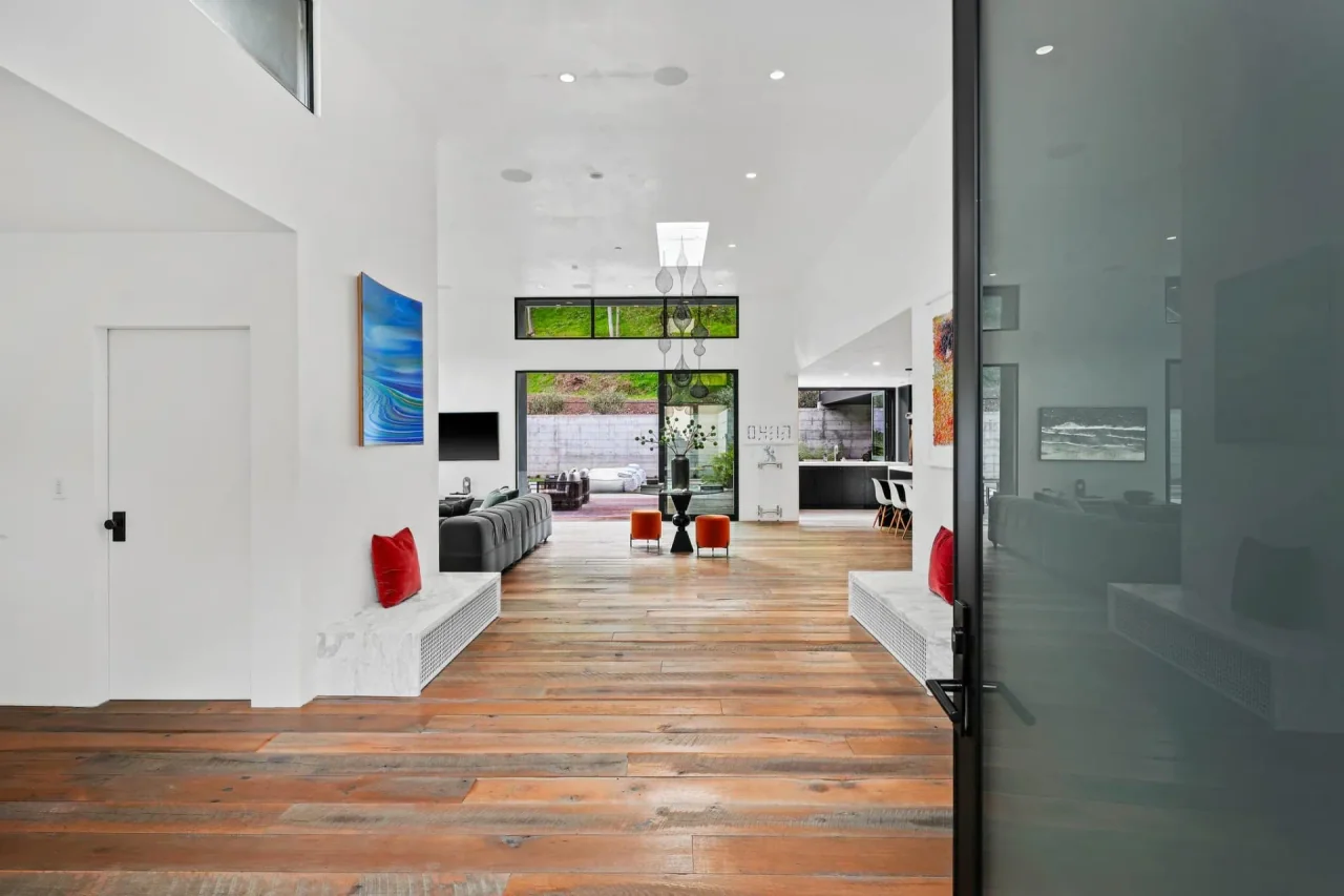 Timber-floor hallway leading to the living area at Rivas Canyon.