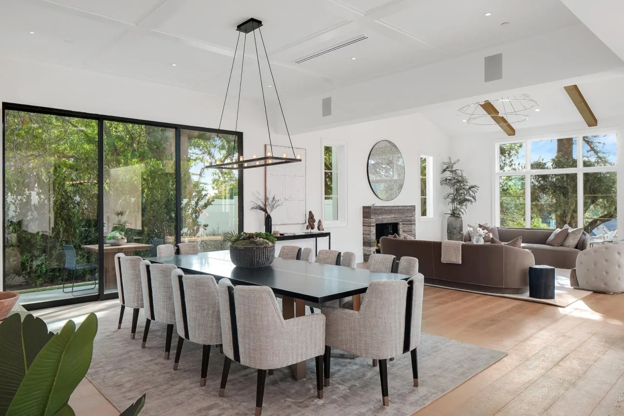 Dining table beside full-height glazing at South Bundy Drive.