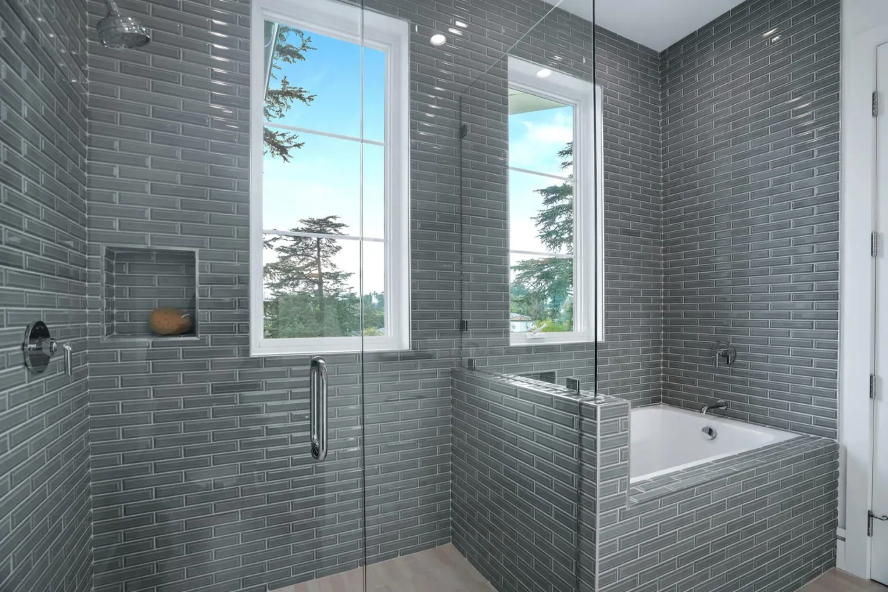 Dark-tiled shower with high window at South Bundy Drive.