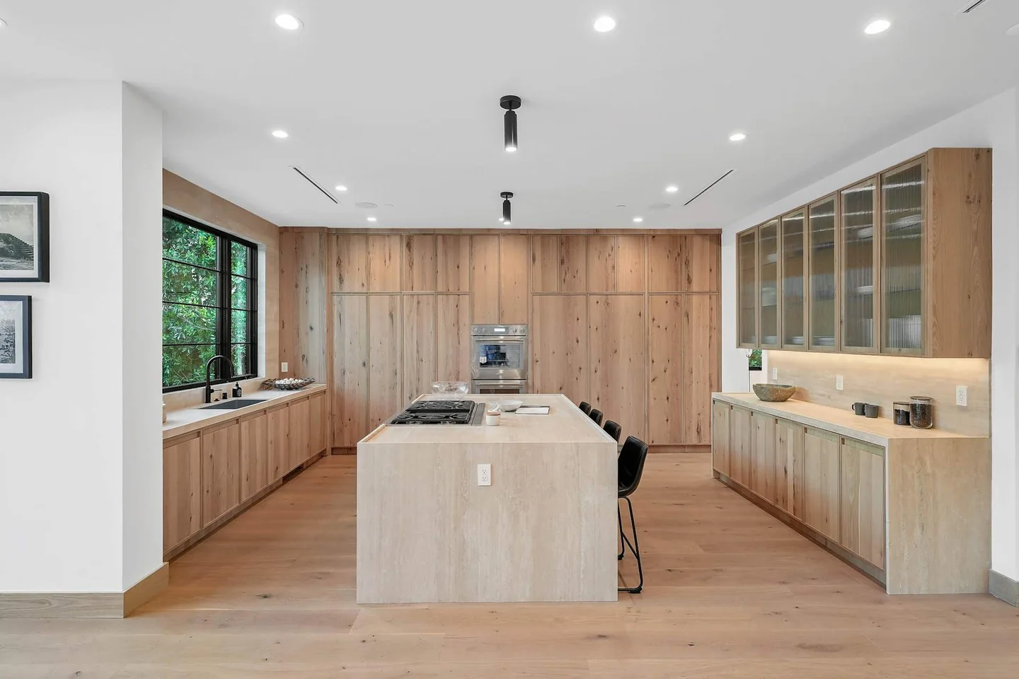 South Gretna Green kitchen with timber cabinetry, a pale island and glazed upper cupboards.