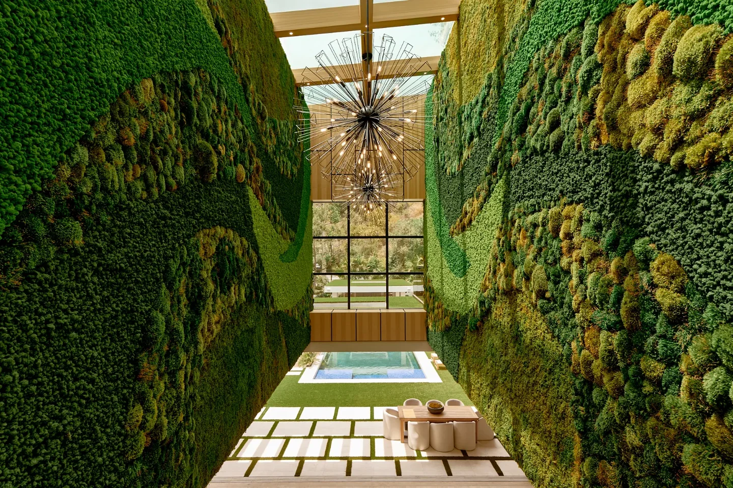 Chalon Road atrium with tall planted walls, overhead glazing and a view to the garden.