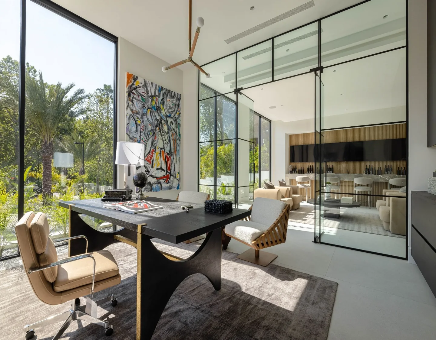 Petit Avenue study enclosed by clear glass, beside tall exterior windows and a timber-lined wall.